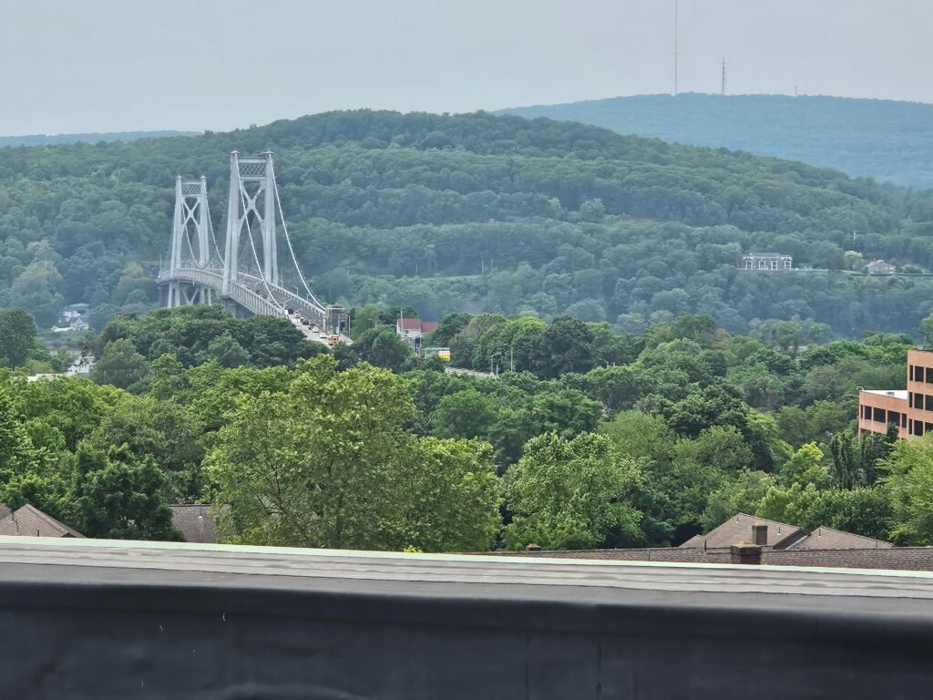 Picture detailing the view of a bridge and mountains and smoke haze taken from the Regional Air Quality Station setup (on the roof of the Adriance Memorial Library).