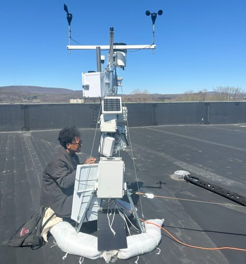 Desiree Lyle, Community Sciences Lab Manager, installing air quality monitoring equipment for a Regional Air Quality Station.